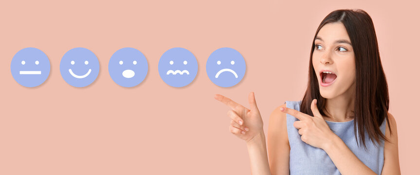 Shocked young woman pointing at many different emoticons on pink background - Powered by Adobe