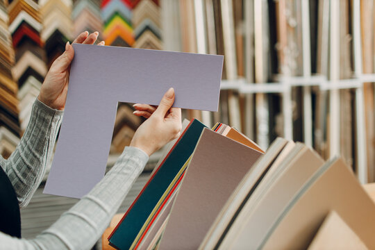 Framing Workshop. Choosing carton cardboard for baguette handmade picture frame at studio.