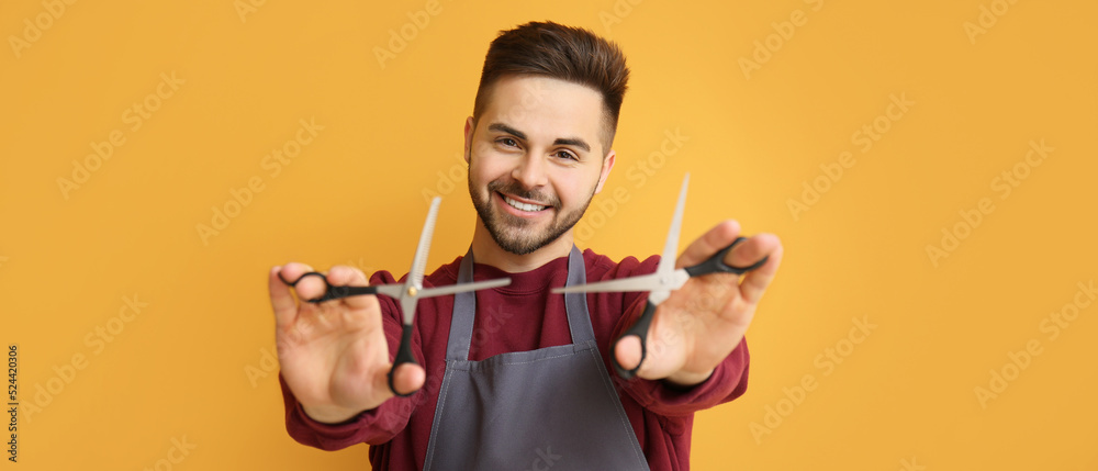 Poster Male hairdresser on orange background