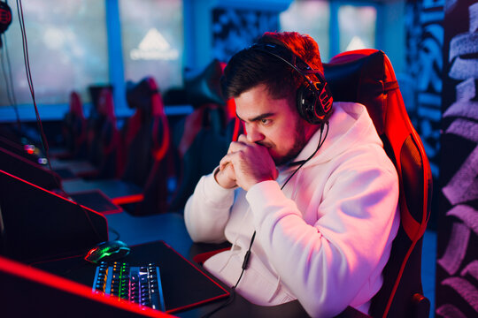 Guy Young man noob newbie gamer loss playing gaming game on computer at game club.