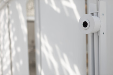 Face recognition system with camera in front of office in white interior indoor door