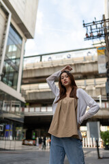 Fototapeta premium Lifestyle portrait photo of a beautiful young asian lady relax and posing around the city after a long pandemic lockdown