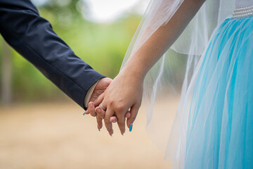 bride and groom holding hands