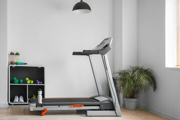 Modern treadmill in interior of gym