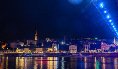 View of the historical city center and the Sava river in Belgrade, capital of Serbia at night. Shot with glares and bokeh