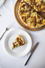 Mushroom pizza on a wooden board. Serving pizza. The chef cuts the pizza. A piece of pizza on a spatula.