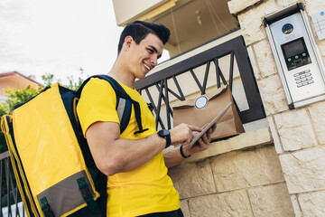 Fototapeta premium Young man delivering online grocery order.