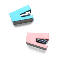 Two colorful staplers on white background