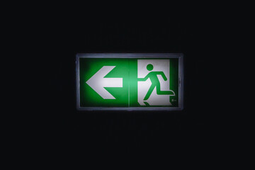 Emergency sign with light in a dark corridor