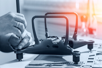 Professional repair of RC drones and radio controlled cars, robots.Broken quadrocopter lies on workshop