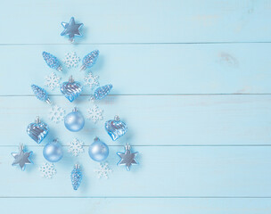 Christmas light blue background. Festive decoration with blue and silver baubles