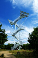 Metal observation tower in Slovakia with beautiful blue sky and clouds. Lookout tower Devinska Kobyla, Bratislava, Slovakia. A tourist attraction.
