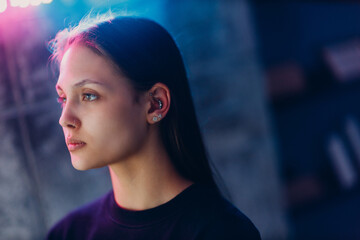 Young woman portrait piercing at beauty studio salon neon light