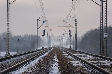 Railway tracks covered with snow in Rogow village, Lodz Province, Poland