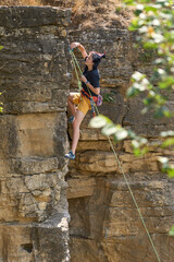 Teenage girl in a difficult rock climbing tour in the Rockgarden  in Hessigheim, Neckar valley, Baden-Wuerttemberg, Germany
