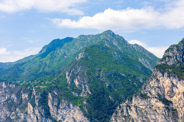 Fototapeta na wymiar Wooded mountain top and rock wall on the northern shore of Lake Garda in Italy