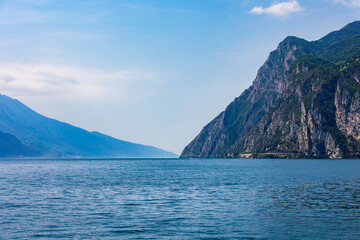 Wooded mountain top and rock wall on the northern shore of Lake Garda in Italy