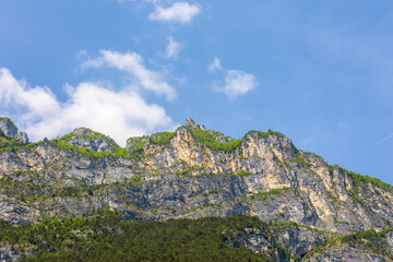 Wooded mountain top and rock wall on the northern shore of Lake Garda in Italy