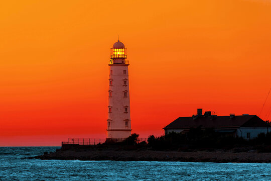 Chersonese lighthouse in selective focus in Crimea, Sevastopol on the Black Sea coast at Cape Tarkhankut, beautiful coastal landscape, evening sea sunset.
