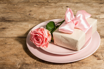 Romantic dinner table on rustic background. Love cutlery for Valentine's or Mother's day, Wedding