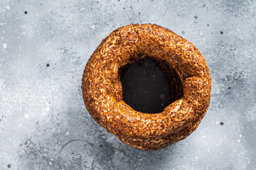 Fototapeta na wymiar Turkish Bagel Simit with sesame traditional pastry. Gray background. Top view