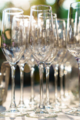 empty wine glasses on an open-air table. the sun's rays in the glass.
