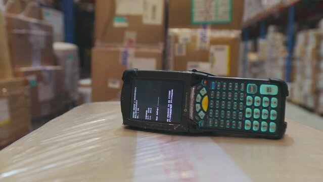 Barcode scanner close-up. Barcode scanner lies on a cardboard box