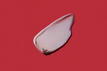 Moisturizing pink cream swatch on bright background, skincare concept