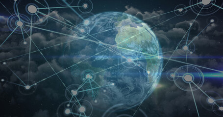 Network of connection over spinning globe against clouds in blue sky