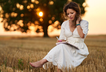 Woman writer in a field