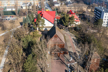 View with wooden church of St Florian and new church in Stalowa Wola city, Poland - obrazy, fototapety, plakaty