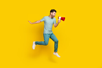Fototapeta na wymiar Full length photo of young attractive screaming guy hold loudspeaker strike low salary isolated on yellow color background