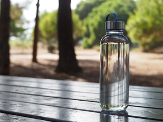 Drinking water in a glass bottle on the table