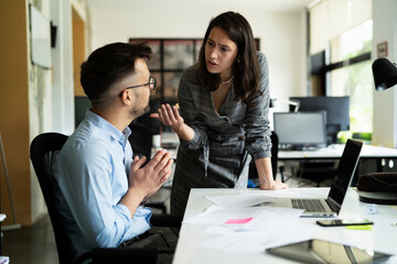 Colleagues arguing in office. Angry businesswoman yelling at her collegue.