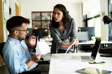 Colleagues arguing in office. Angry businesswoman yelling at her collegue.