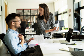 Colleagues arguing in office. Angry businesswoman yelling at her collegue.