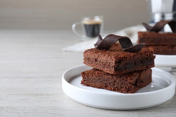 Delicious chocolate brownies on white wooden table. Space for text