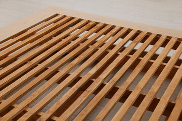 Closeup view of new wooden bed frame indoors