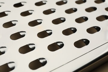 Modern metal grater as background, closeup view