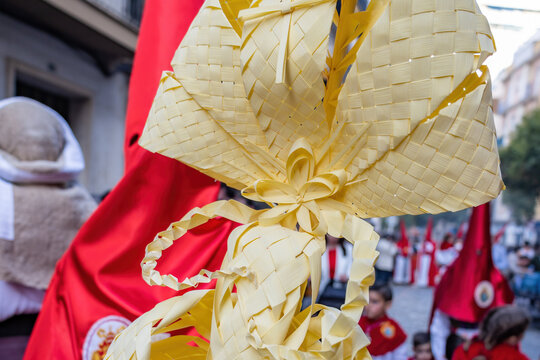 Detail of a Palm made in Elche, Spain, carried by a Nazarene and penitent, in Palm Sunday, during Holy Week, in the La Borriquita procession