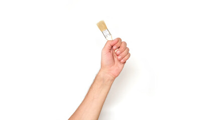 Male hand holding a paint brush on a white background