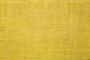 Texture of yellow burlap fabric as background, top view