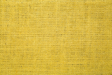 Texture of yellow burlap fabric as background, top view