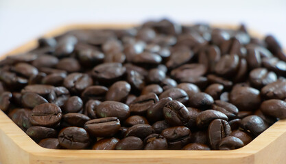 Close-up of roasted coffee beans in a wooden tray, perfect for barista, cafe, or home brewing concepts, highlighting rich aroma and dark roasted texture for coffee lovers and beverage industry
