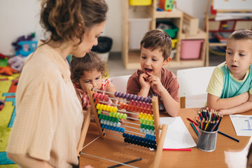 teacher with children at child daycare