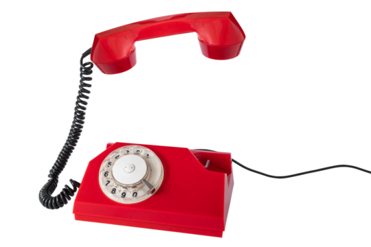 Old red rotary phone with the receiver raised in the air