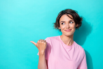 Photo of lovely short hairdo millennial lady indicate look empty space wear pink t-shirt isolated...