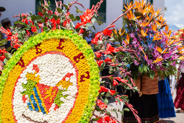 People wearing floral art on their backs. Colorful handmade floral decorations forming figures.