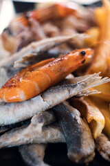 Delicious Adriatic fish and chips - grilled seafood (baby octopus, shrimps, sardina, mussels and calamary rings) with French fries