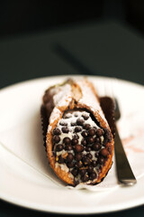 Classic Sicilian cannoli - crisp tubes of golden-brown fried dough filled with a creamy ricotta, candied fruit, and chocolate filling